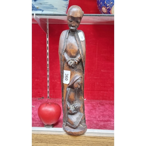 360 - A hand carved wooden sculpture depicting The Holy Family.