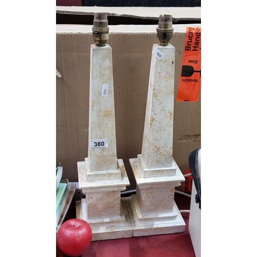 380 - A pair of carved wooden table lamps in the form of obelisks, with baize lining to base.