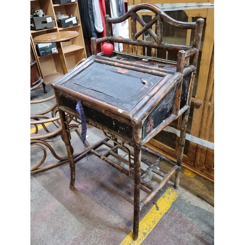 407 - A eye-catching Victorian bamboo writing desk boasting floral detailing. With writing slop and space ... 