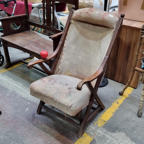 423 - An antique Edwardian high back wooden frame arm chair. Frame is solid and seat still well sprung but... 