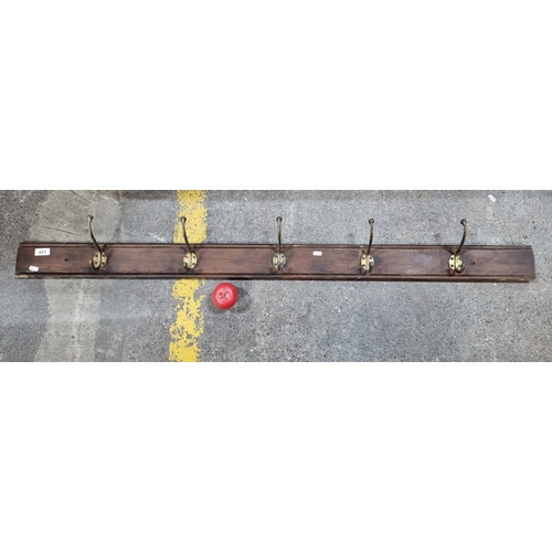 451 - A set of five mounted vintage metal hat and coat hooks.  From the basement enterance of the amazing,... 