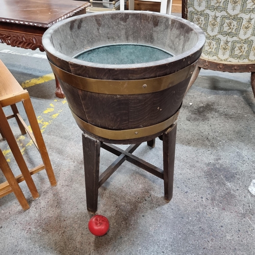 454 - Star Lot : An  antique  oak half barrel brass bound planter with metal lining.  From the garden of t... 