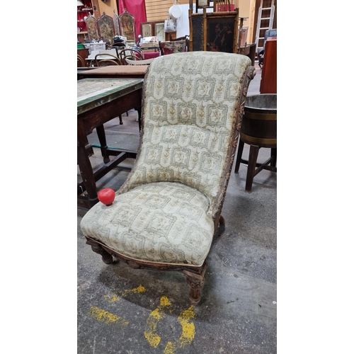 459 - A beautiful mid Victorian slipper chair with scrolled back and floral carving throughout wooden fram... 