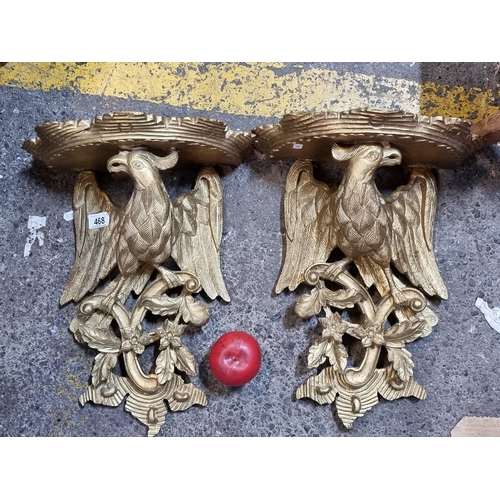 468 - Star Lot : A super pair of George II style molded antique gilt bracket sconces featuring eagle desig... 