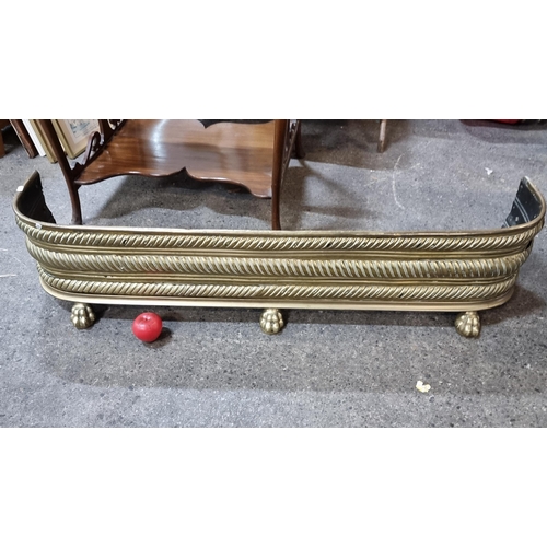 475 - Star Lot : A fabulous large Victorian brass pierced fire fender with lion paw feet and boasting barl... 