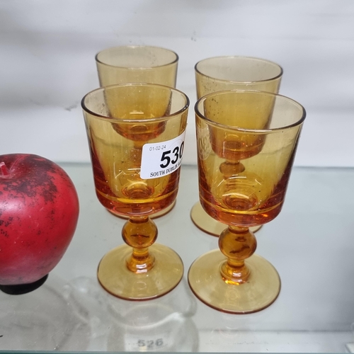 530 - A stunning set of four vintage hand blown  amber glass knotted stem drinking goblets. From the amazi... 