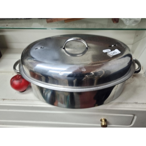 540 - A wonderful large oval stainless steel roaster, features a domed lid that helps to keep food moist.