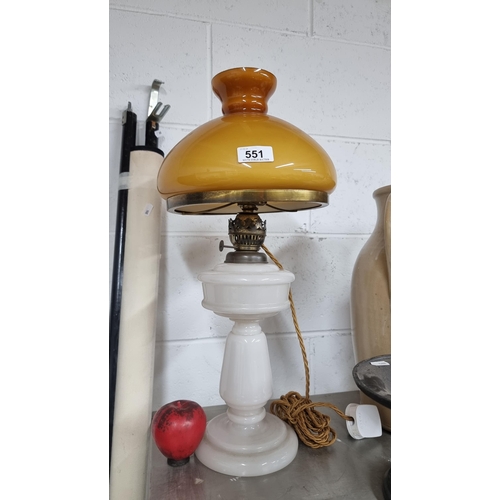 551 - A stunning early oil lamp featuring milk glass base and reservoir along with a fabulous amber glass ... 