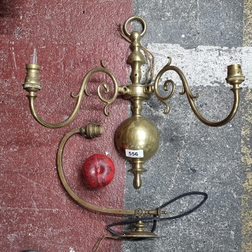 556 - Two stylish brass light fittings including a two branch example as well as a single example. From th... 