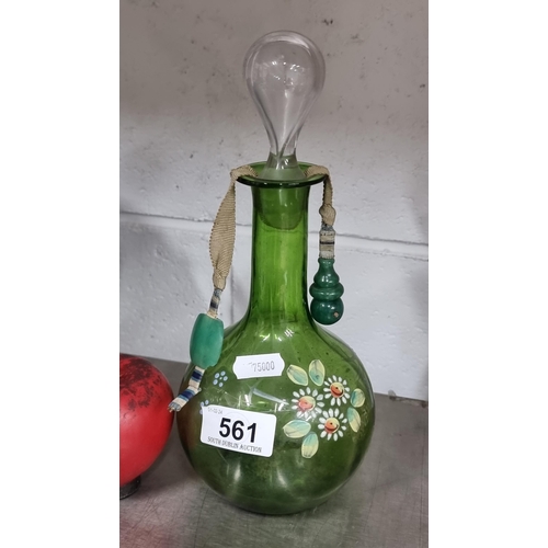 561 - A gorgeous green glass decanter with hand painted floral detail and cord with jade stone ends. Stopp... 