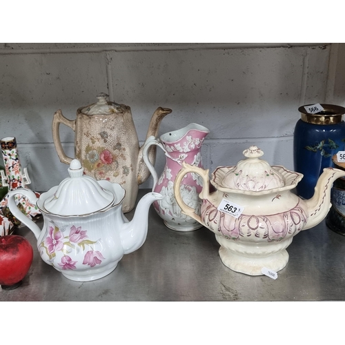 563 - A fabulous antique hand painted ceramic teapot with a floral design, along with a modern Polish exam... 