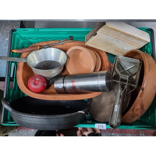 574 - A mixed kitchen lot consisting of terracotta cooking pots and baking dishes, thermos, strainer, carv... 