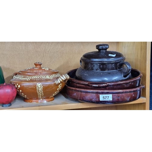 577 - A lidded ceramic cooking pot in a soft brown glaze, along with two large stoneware serving bowls / p... 