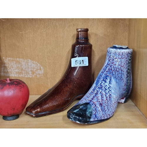 581 - Two fabulous antique ceramic boot warmers, one in a treacle glaze, the other featuring a bright red ... 