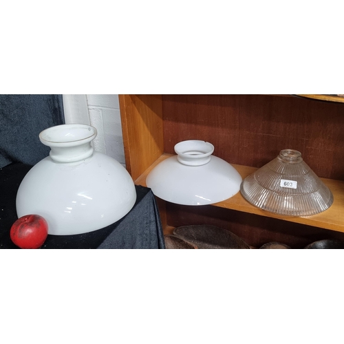 603 - Three vintage glass lamp shades including two milk glass examples and a clear tactile example. Sligh... 