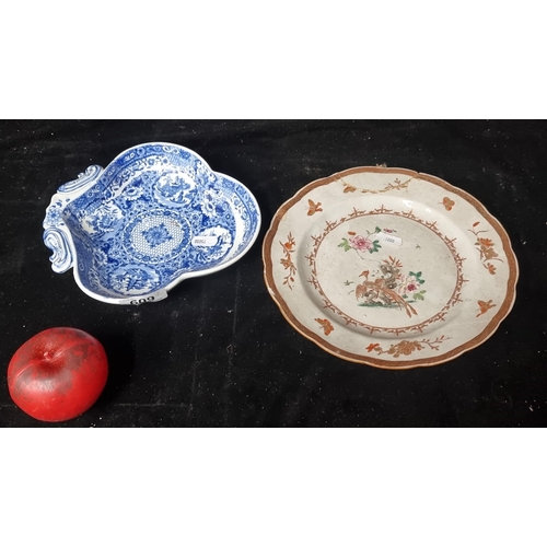 609 - Two antique plates including a trefoil shaving bowl example with blue Chinese design and another fea... 