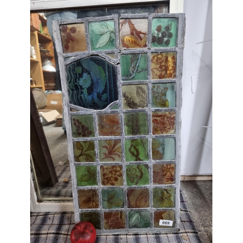 669 - A lovely stained glass leaded window with hand painted squares with hedgerow plant designs. H32cm x ... 