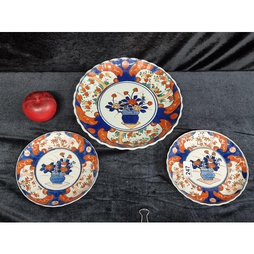 247 - Three matching antique Imari plates including a large plate and two side plates. The large plate has... 