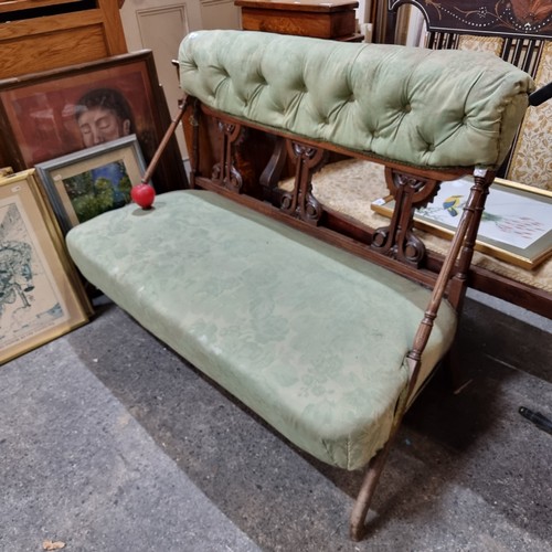 483 - Star Lot : A very elegant Victorian two-seater sofa with an unusual carved backrest and turned suppo... 