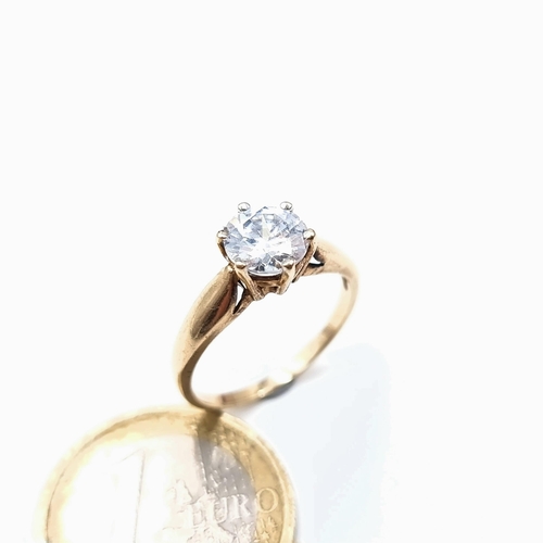 675 - A very pretty  cubic zirconia solitaire ring set in gold, In 9K gold band, size O, weight 2.48 grams... 