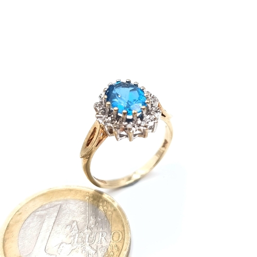 676 - Star Lot : A beautiful blue topaz ring with diamond cluster surround, mounted in 9K gold (375), ring... 