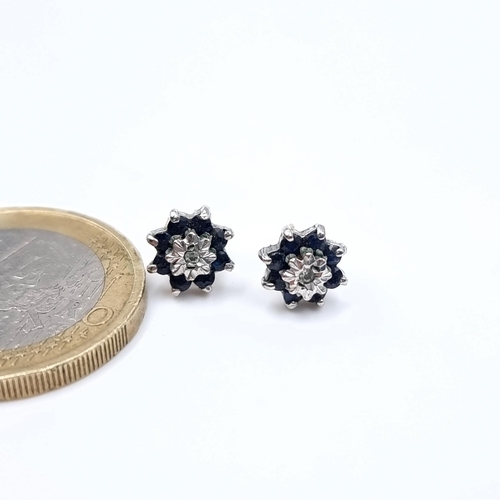 690 - Star Lot : A pair of lovely diamond and sapphire 9K gold stud earrings.