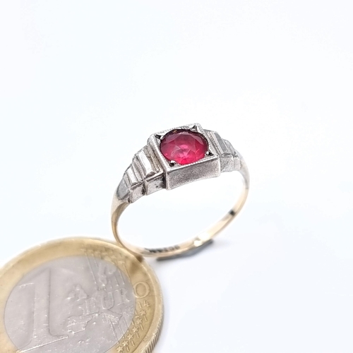 711 - Star Lot : A 9K white gold diamond and ruby stone ring, size M, weight 2.57 grams, boxed.