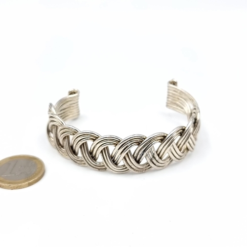 752 - A twist link torc bracelet , weight 37 grams.