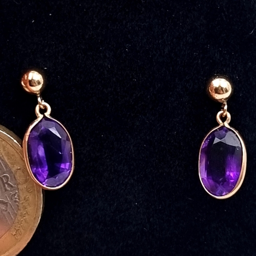 762 - A lovely pair of 9K gold amethyst stud earrings with backs, boxed.