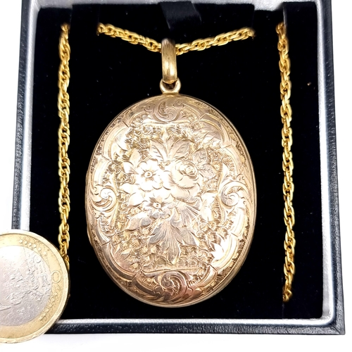 765 - A fine example of a vintage pendant locket and chain, locket finely detailed to front and back with ... 