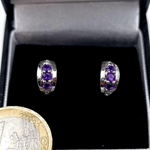 770 - Star Lot : A very fine pair of 9K white gold amethyst and diamond stud earrings, old new stock, neve... 