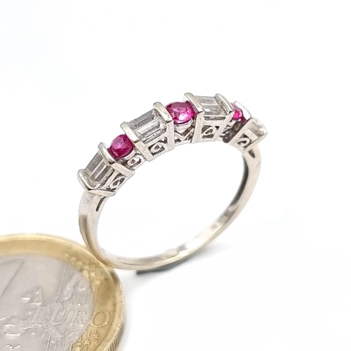 778 - Star Lot : A fine example of a ruby and diamond half eternity ring, set in 10K white gold, size P, w... 