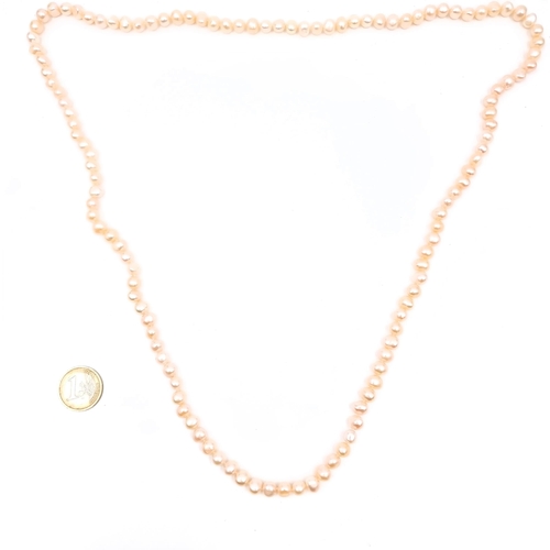 791 - A lovely long pink lustre natural  freshwater pearl necklace, length 86cm.