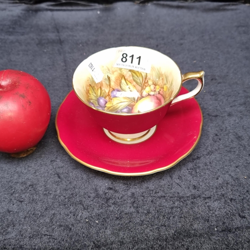 811 - A charming vintage Aynsley teacup and saucer boasting a fruit motif with red and gilt detailing. C.1... 