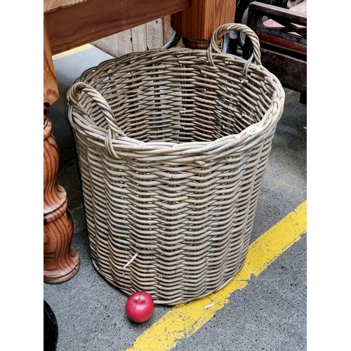 827 - A charming large heavy duty double handled whicker basket.