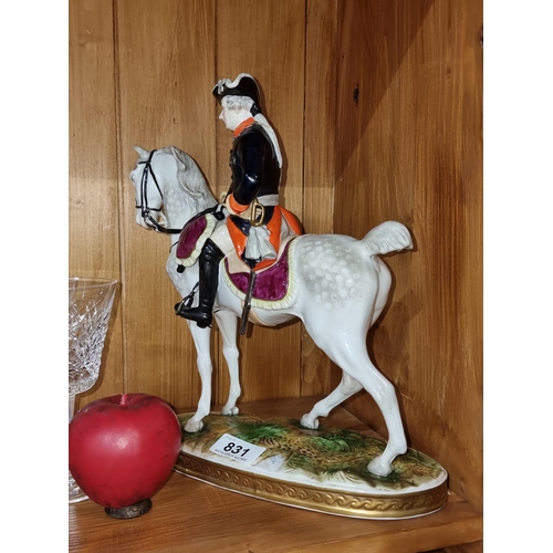 831 - A fabulous large German porcelain figure of a solider on horseback.