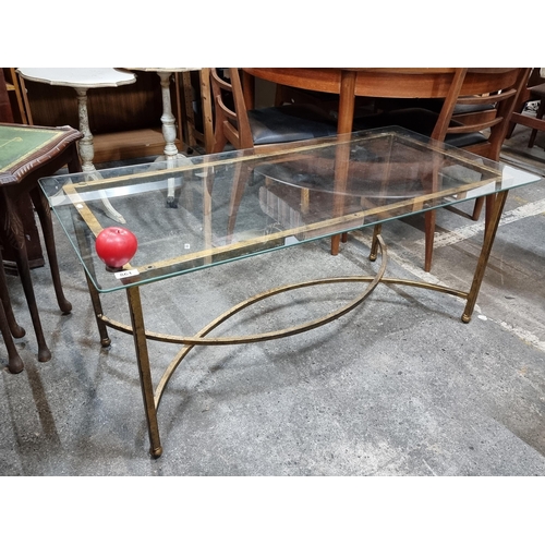 861 - A handsome coffee table with tempered glass top, held on a brass toned frame.