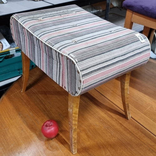 862 - A charming mid century footstool with button back detail, upholstered in a striped fabric with stud ... 