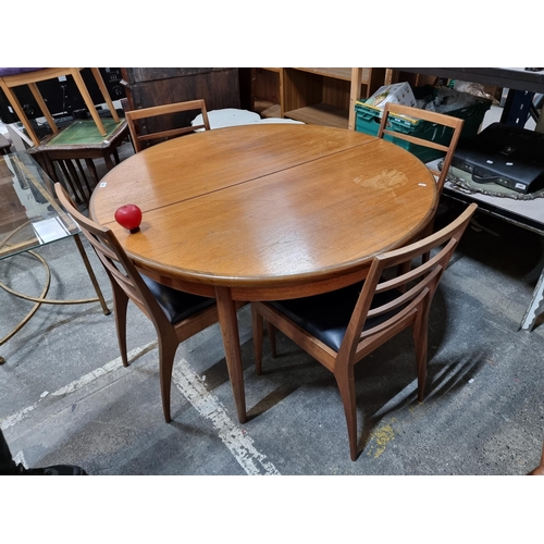 864 - Star Lot : A fabulous vintage mid century extending dining table, with round top and held on tapered... 