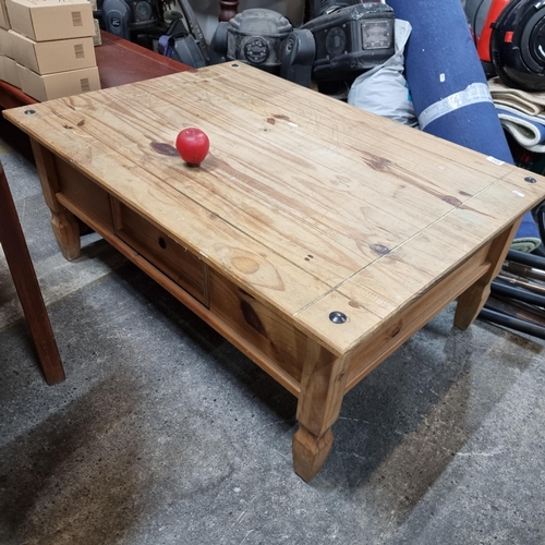 882 - A good quality pine coffee table with a drawer and stud detailing to corners.