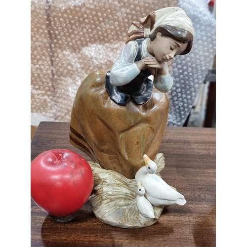 901 - An adorable Lladro handmade figure of a farmer girl with her ducks.