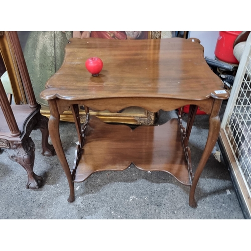 928 - Star lot : A handsome Edwardian window table boasting profuse scroll edges, shelf to base and cabrio... 