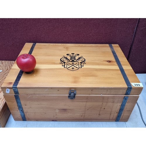 399 - A good quality wooden case with heraldic crest to front, opening to reveal large central storage spa... 