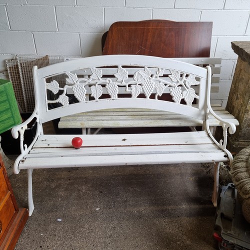 942 - Star Lot : A charming vintage cast three-seater garden bench with an attractive metal backrest featu... 