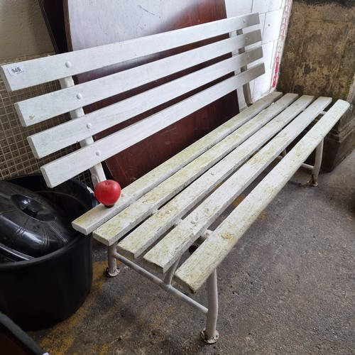 945 - A three-seater garden bench with wooden slates and metal supports in a white finish.