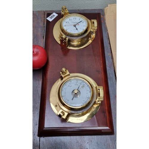 990 - A handsome clock with barometer featuring brass fittings and wooden plaque.