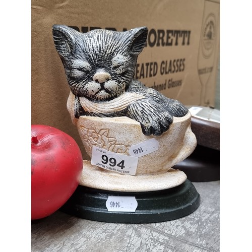 994 - An adorable cast metal door stopper in the form of a sleeping cat in a teacup.