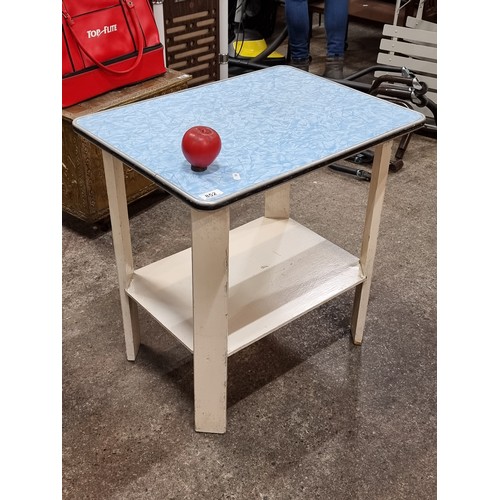 852 - A funky and unusual mid century three tiered table with laminate top .