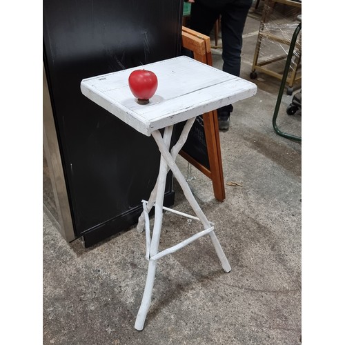 856 - A rustic handcrafted side table with a tripod base made from natural branches in a white finish.