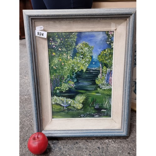 924 - A delightful original oil on board painting featuring a lush landscape view of a river lined with de... 